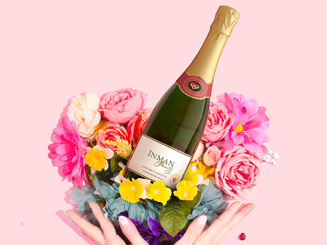 Bottle of Inman Family Extra Brut Lux Cuvee on a collection of flowers