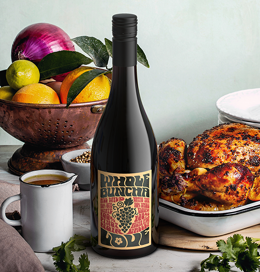 Bottle of Inman Family Whole Buncha Love Pinot Noir next to a roast chicken and jug of gravy